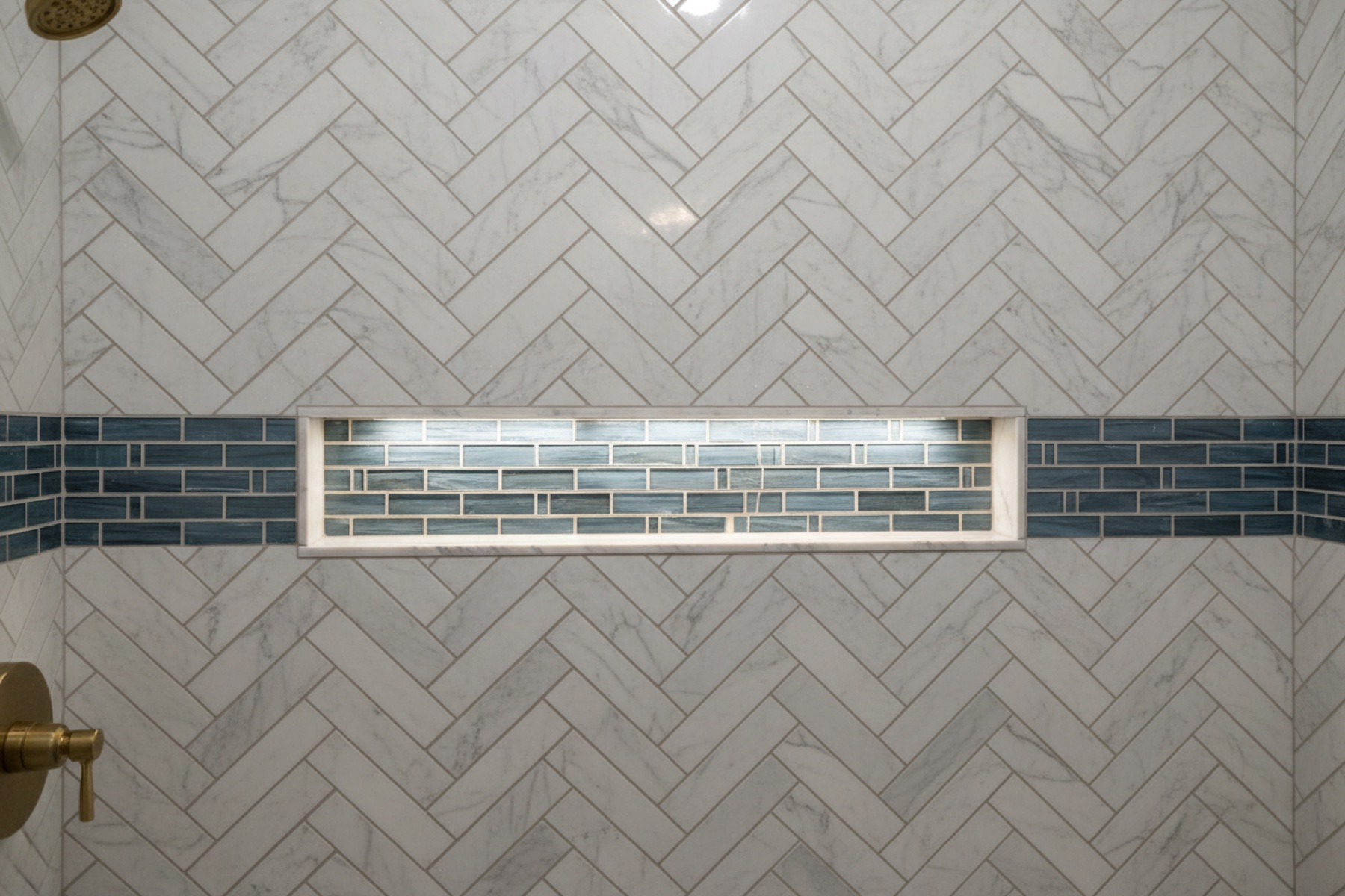 Custom tile shower with niche and decorative band