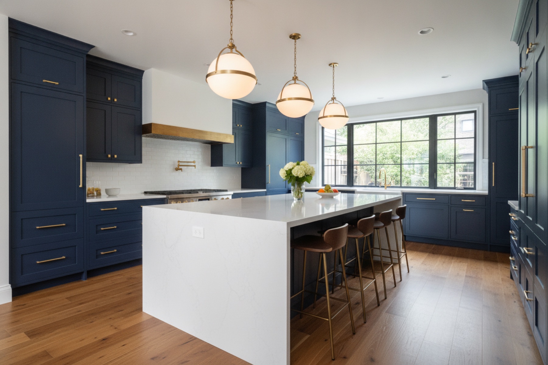 Remodeled kitchen with large quartz island and pendant lighting